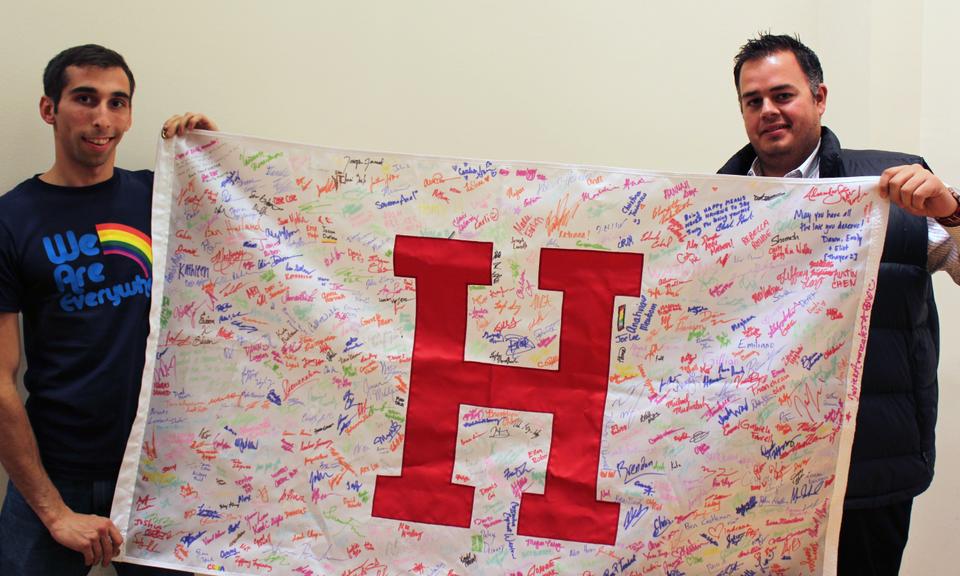 Joe J. Vitti '10 and Clark Goodwin display a banner of signatures from the Class of 2016 in support of National Coming Out Day. The large turnout at the Coming Out Narratives forum was a pleasant surprise to organizers. 