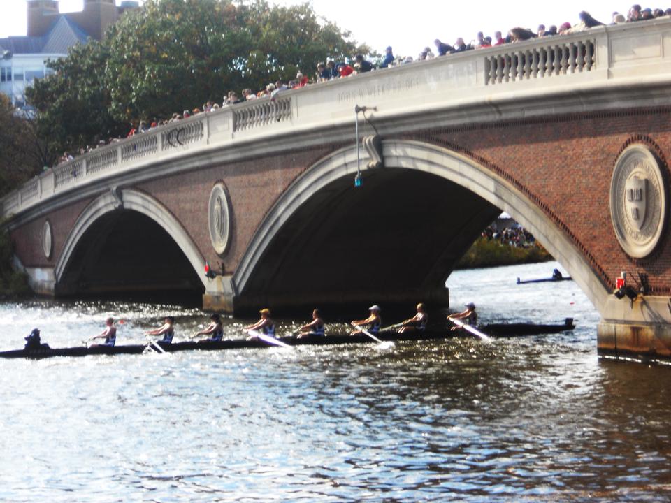 Spectators fill the bridges over the Charles, nudging their way in to the coveted railing spots, ready to cheer on their rowers. 