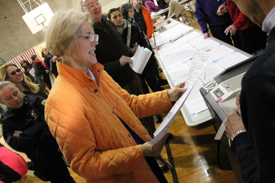 Elizabeth Warren looks over her ballot one last time before casting her vote at the Graham and Parks School polls on Tuesday morning in Cambridge, Mass.