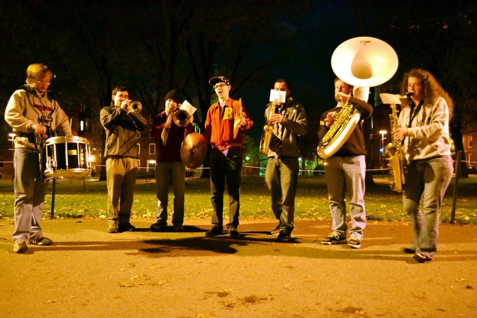 Members of the Harvard University Band perform an impromptu rendition of "The Star Spangled Banner" in front of the John Harvard statue in Harvard Yard after hearing the news of President Barack Obama's re-election.