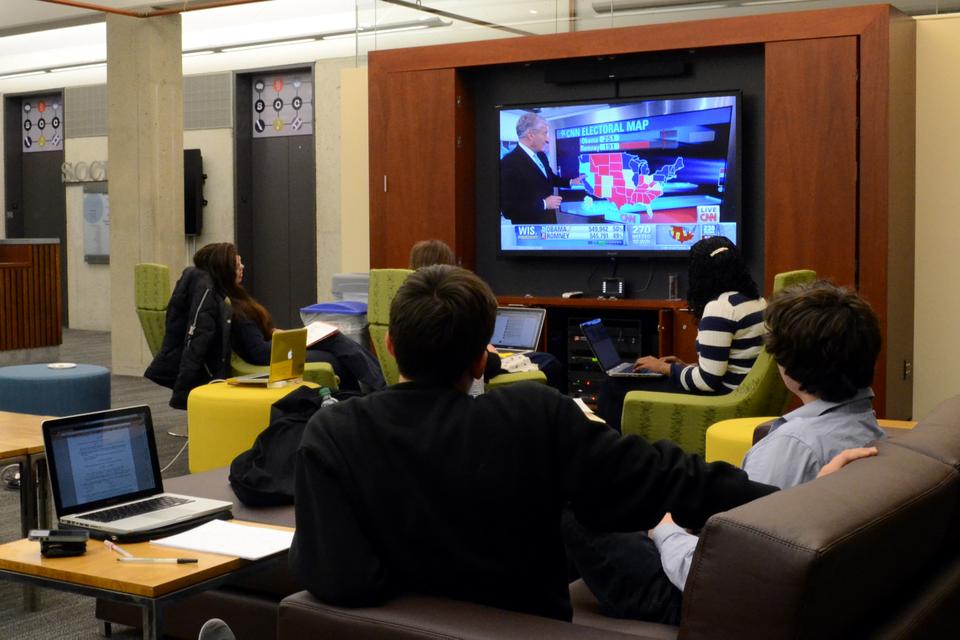 Students watch presidential election projections in the SOCH