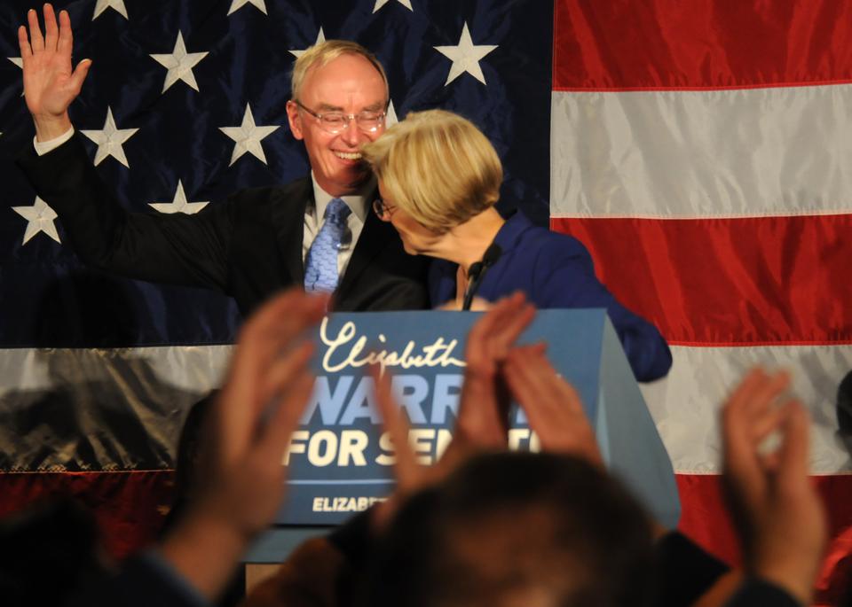 Senator-elect Elizabeth Warren and her husband Bruce Mann, who is a professor at Harvard Law School, share a moment onstage after Warren's victory speech Tuesday night.