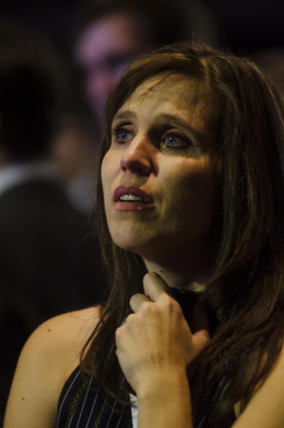 A teary-eyed Romney supporter is unable to hold back her emotions in the Convention Center's ballroom as she watches the results in disbelief.