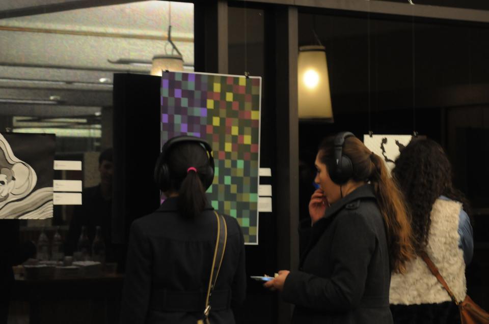Artists and visitors examine art pieces as they listen to corresponding music compositions at the Art of Sound exhibit at the SOCH. The exhibit will run from November 29 to December 15. 