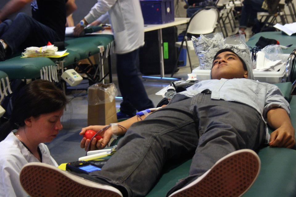 Red Cross Collection Specialist Jasmine McDonough finishes prepping Dillon Druz '16 for his blood donation on Monday December 3rd. According to Dillon, he is willing to take an hour of his time so that his pint of blood can potentially save three lives. 