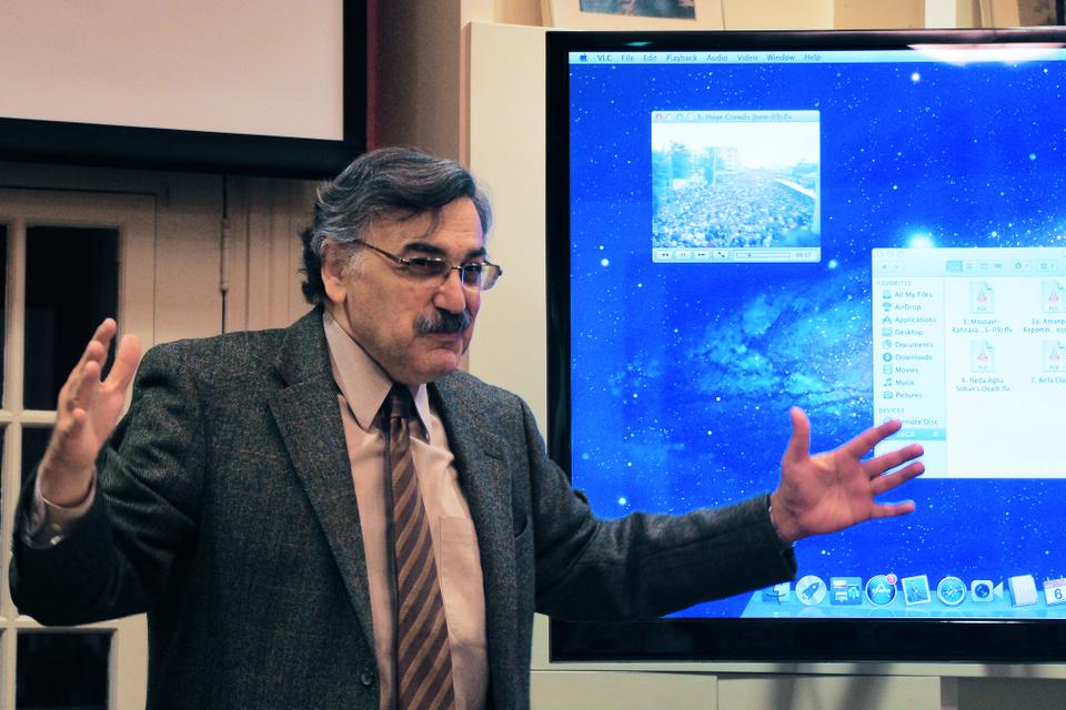 Ali Banuazizi, Professor of Political Science at Boston College, emphasizes the massive number of Green movement supports present during demonstrations as he shows clips of some of these events. He spoke at the Harvard Center for Middle Eastern Studies about Iran's Green movement and the Arab Spring movement on Thursday. 