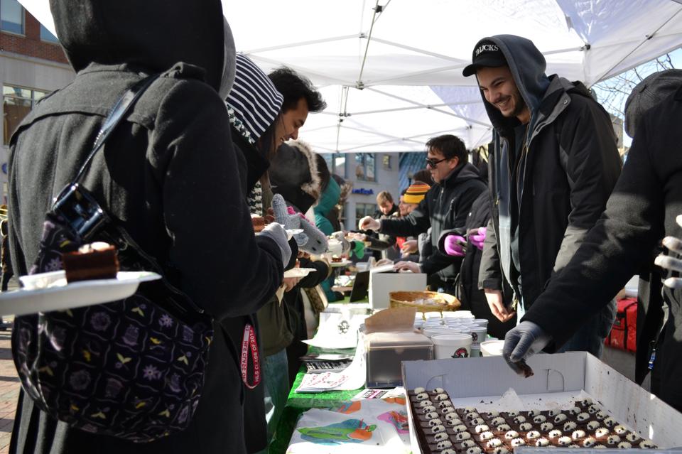 In celebration of Harvard Square's annual Chocolate Festival, local restaurants congregate to hand out free chocolate samples to a long line of people braving the cold weather for sweets and coupons.