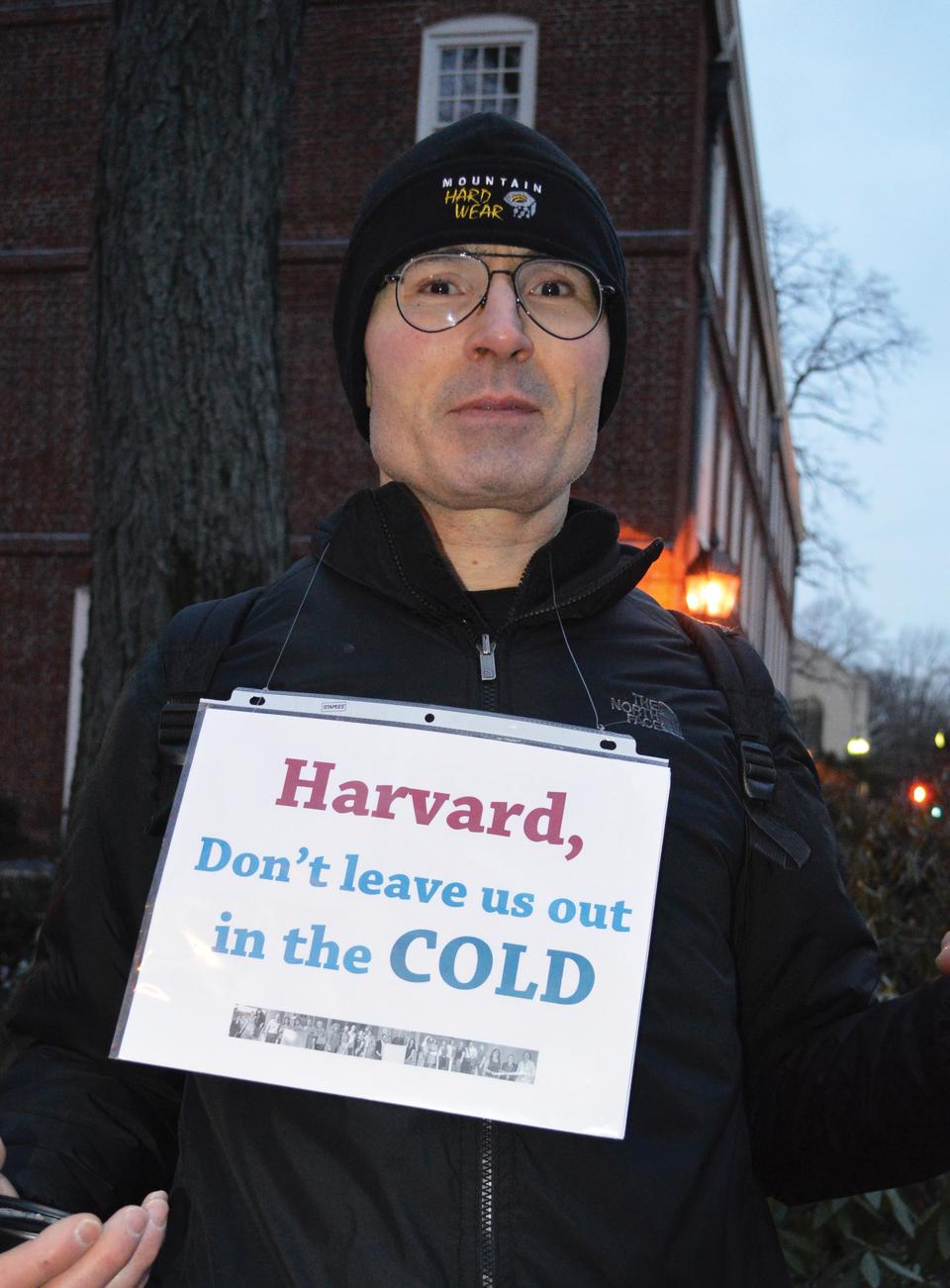 Aryt Alasti, a Harvard security guard and member of The Harvard Union of Clerical and Technical Workers, protests outside of Massachusetts Hall on Tuesday to urge the University to agree to favorable terms in continuing contract negotiations.