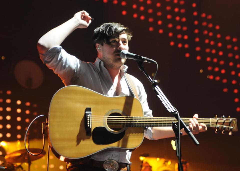 Lead singer, Marcus Mumford, engages the crowd. An English-born musician, Mumford plays the guitar, drums, and mandolin.