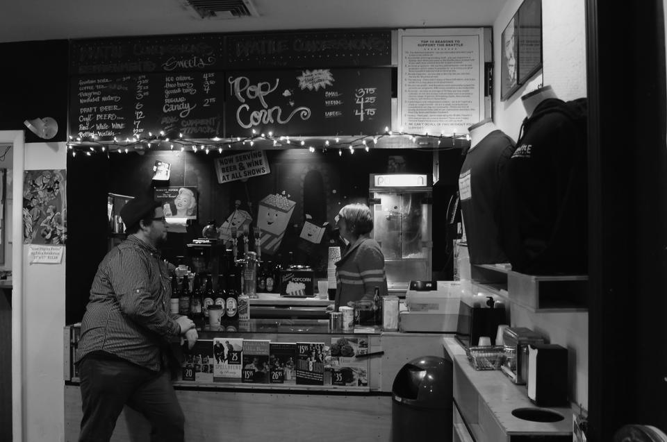 Ned Hinkle, creative director of the Brattle Theater, checks in on one of his managers, Kelly McMaster. 