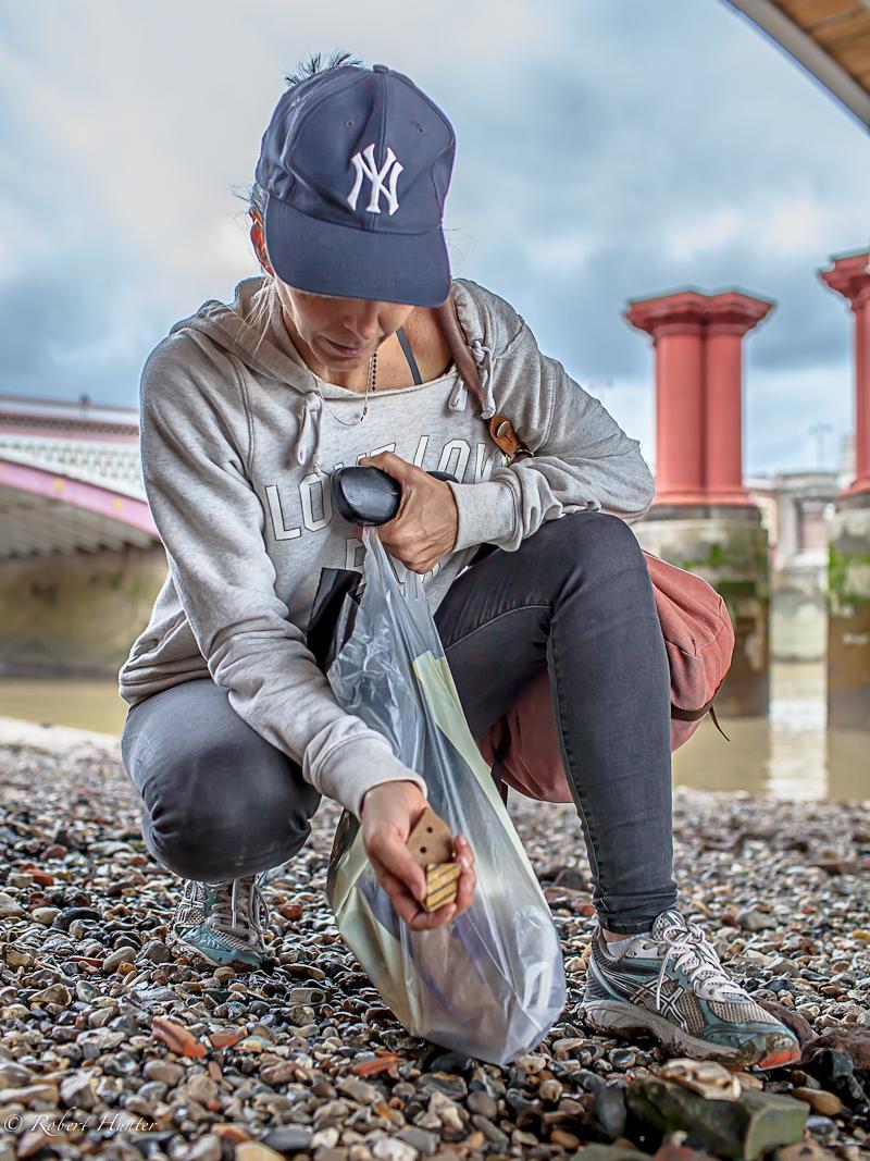 Michelle Erickson collects artifacts on the bank of the Thames River in London for use in her work.