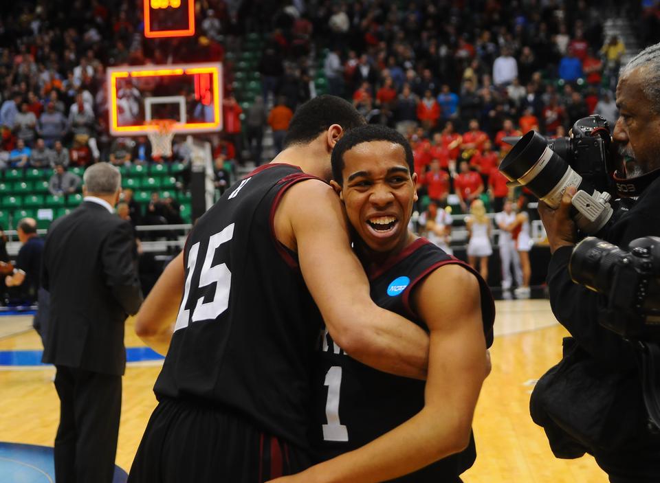 Christian Webster and Siyani Chambers celebrate the Harvard men's basketball team's victory over the University of New Mexico in the second round of the NCAA tournament.