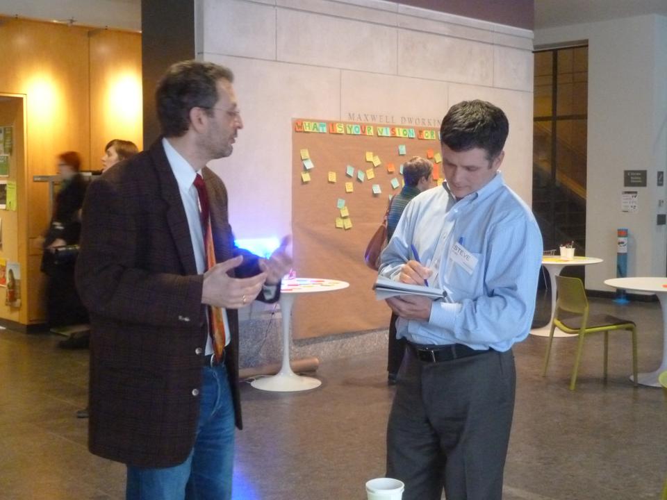 Computer science professor Stuart M. Shieber ‘81 speaks with architectual consultant Stephen J. Erwin about the design of the SEAS Allston campus at an open house event in Maxwell Dworkin Monday afternoon.