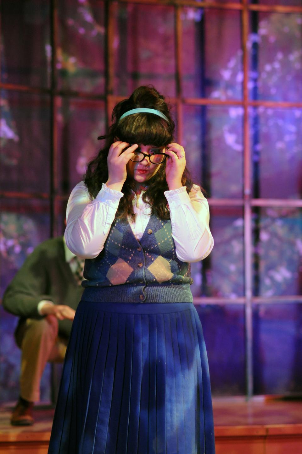 Helena, portrayed by Aliana de la Guardia, takes off her glasses in frustration at the love tangle in which she is trapped.