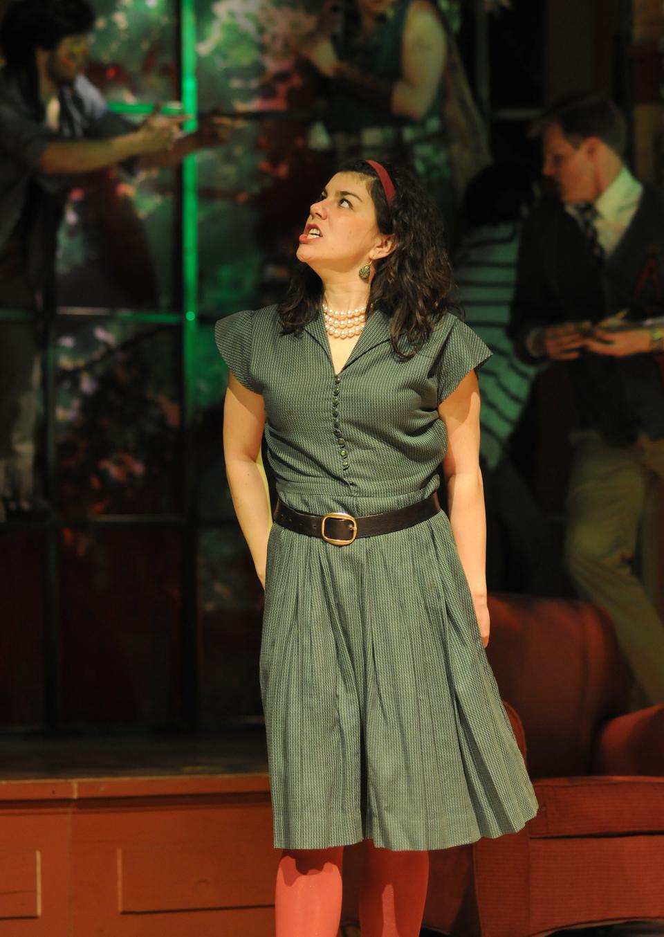Hermia, played by Sophie Michaux, looks angrily up at Helena (not pictured) mid-argument. 