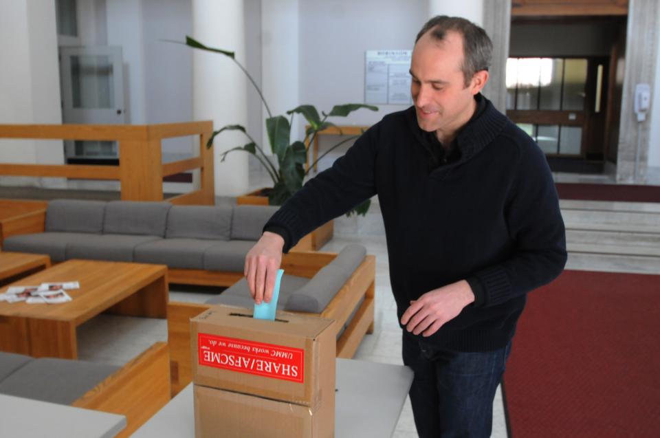 With the union negotiations over, HUCTW member Matthew Corcoran casts his vote on accepting the new contract in Robinson Hall on Tuesday afternoon. 