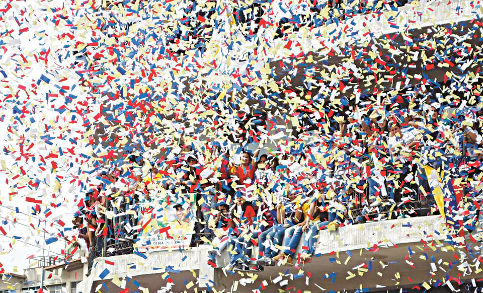 Confetti falls on supporters at a rally for Venezuelan presidential candidate Caprilles this weekend.  The vote was to replace Hugo Chávez.