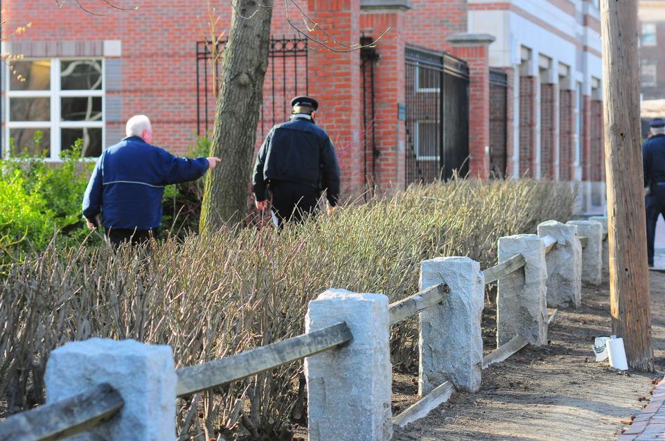 Harvard University Police Department officers scan the sides of the Kennedy School's Belfer Center, shortly after the school ordered a mandatory evacuation.