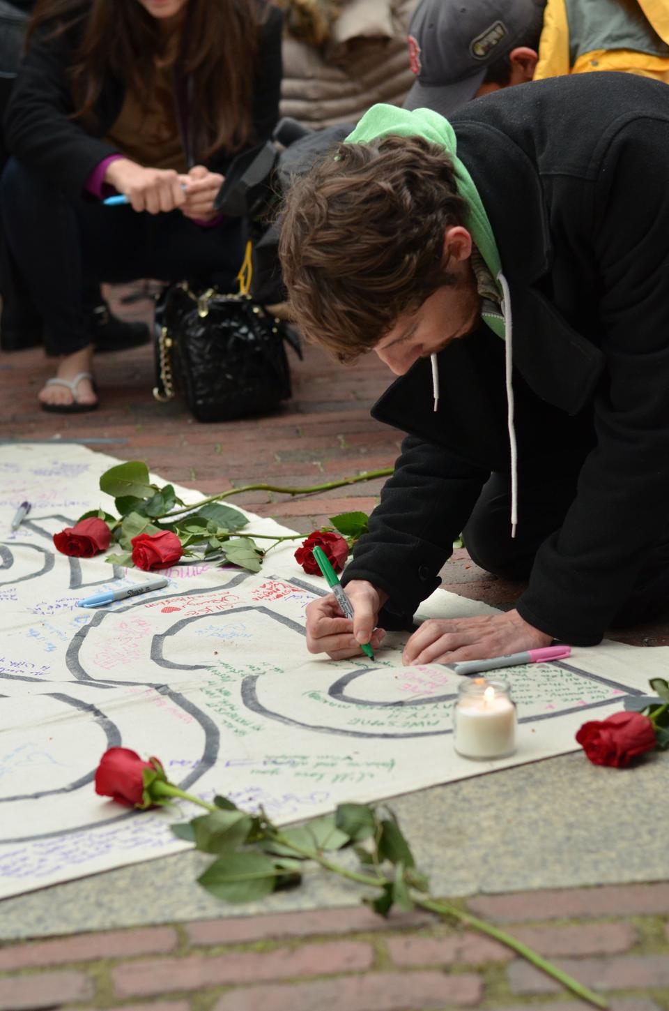 Hundreds of people gathered in the Boston Common for a vigil honoring the victims of the Boston Marathon explosions. Many signed banners with personal messages, lit candles, and joined in with the performing choir.
