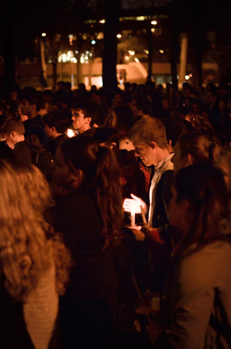 Members of the Harvard community gather outside Memorial Church at a candlelight vigil to commemorate all those who suffer as a result of the Boston Marathon explosion. 