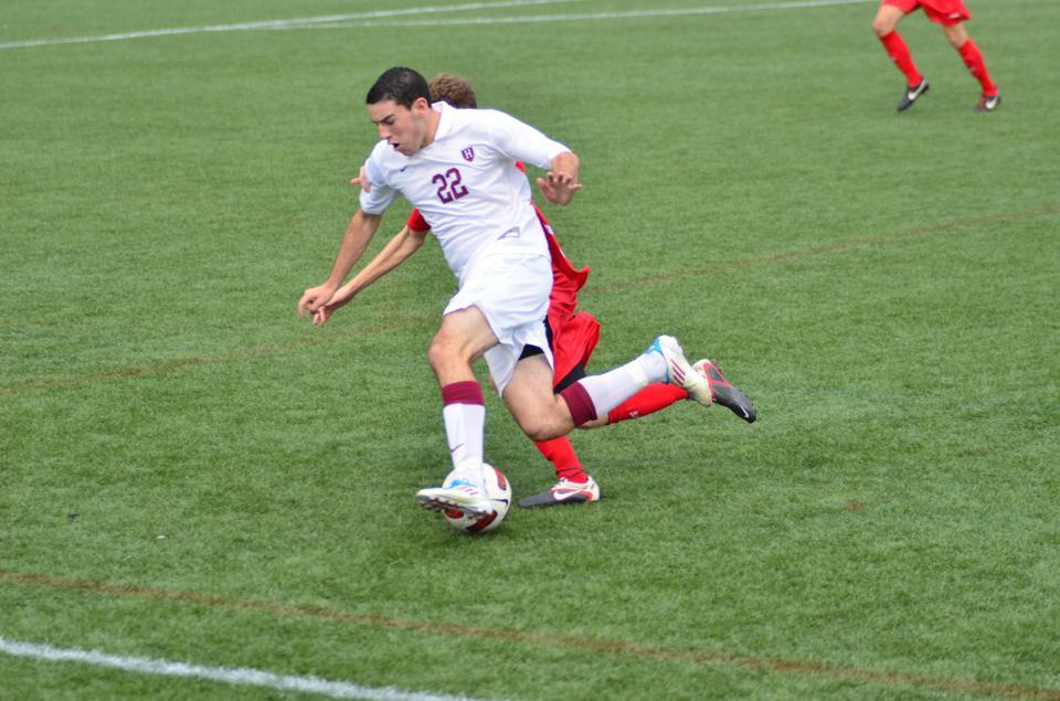 Freshman Jake Freeman, shown here in previous action, led the men's soccer team in its Tuesday night exhibition game against Boston University. The Crimson fell to the Terriers, 2-1. 