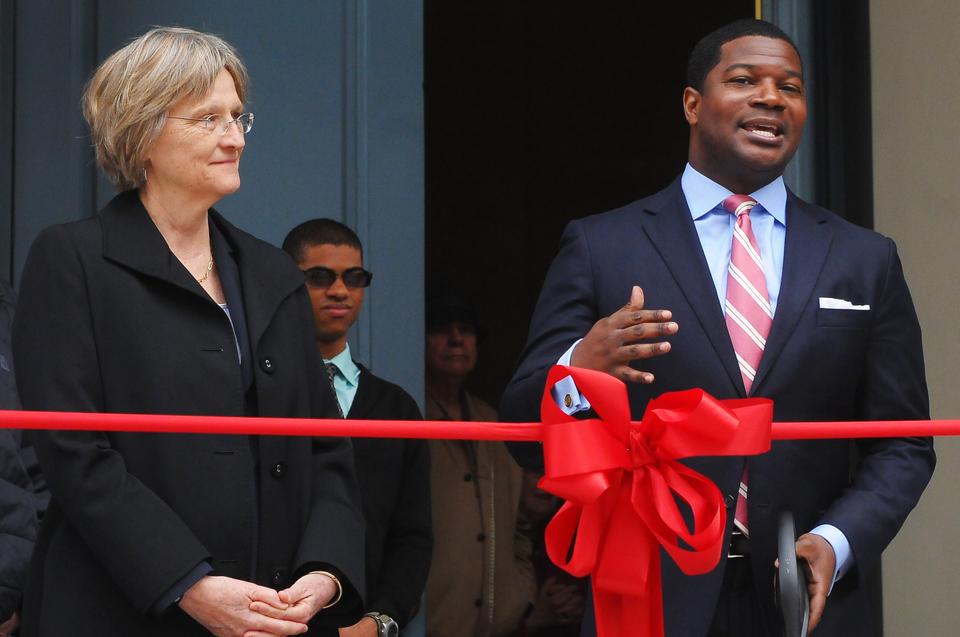 
President Drew G. Faust watches as Jonathan L. Walton, the Pusey Minister of the Memorial Church, speaks at the opening of the Porch, Harvard's newest Common Space. The ribbon-cutting ceremony Wednesday morning included coffee and baked goods from Memorial Cafe, and began at the close of morning chapel. 