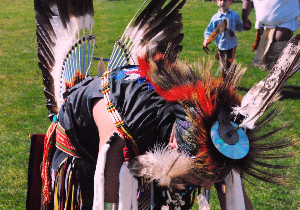 A man dressed in traditional attire dances at the 18th Annual Harvard Powwow. The powwow was held this Saturday on the Radcliffe Lawn.