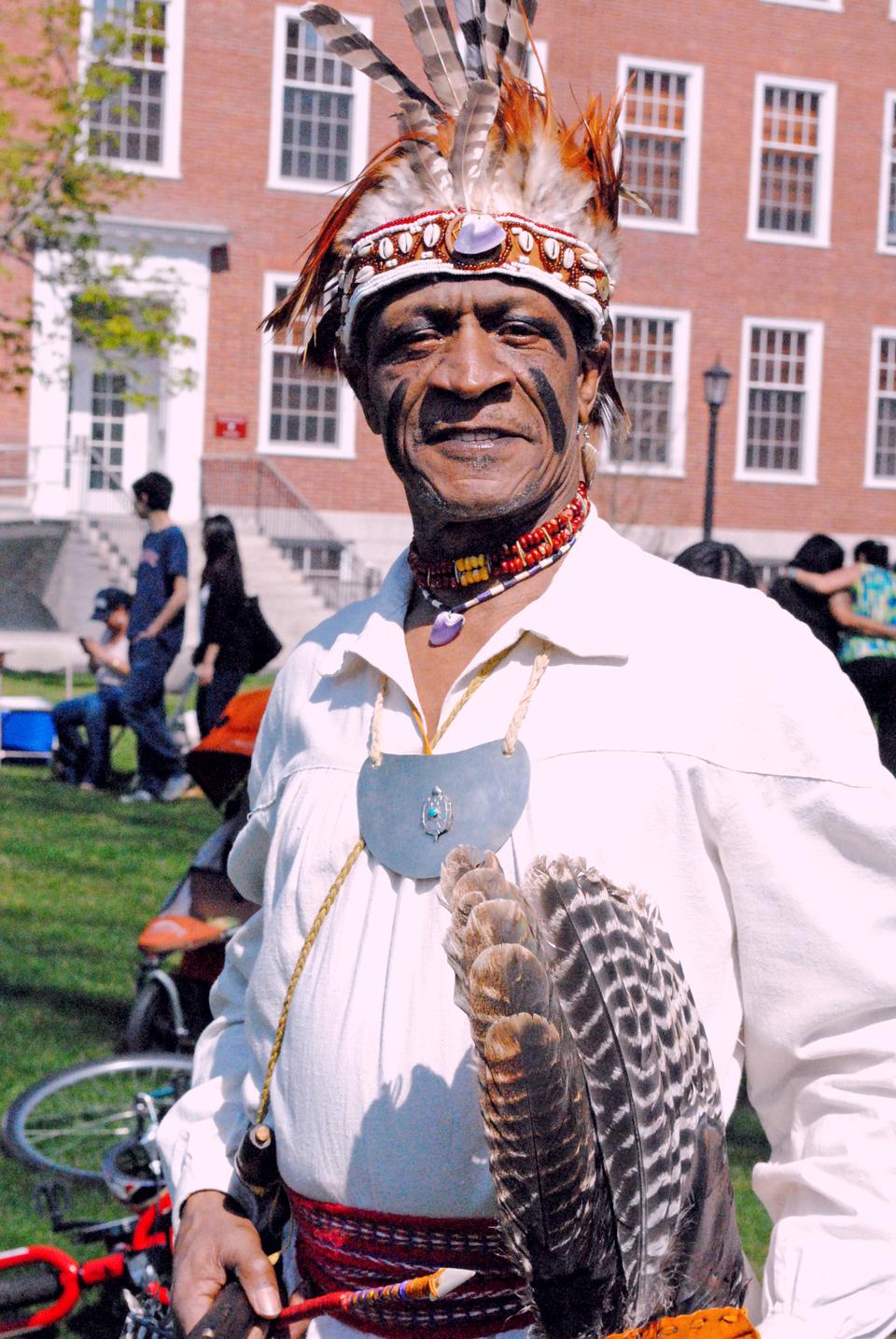 A man dressed in traditional attire attends the 18th Annual Harvard Powwow. The powwow was held this Saturday on the Radcliffe Lawn.