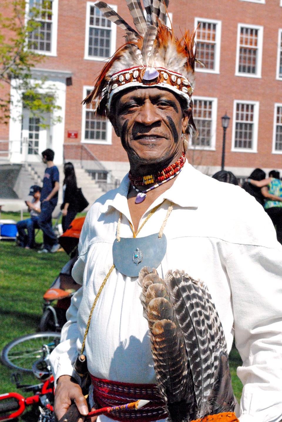 A man dressed in powwow regalia attends the 18th Annual Harvard Powwow, sponsored by the Harvard University Native American Program, and featuring dance competitons and crafts, on the Radcliffe Lawn on April 20.