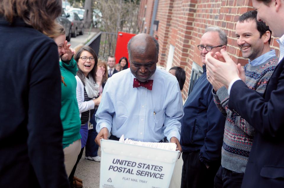 Senior Admissions Officer David L. Evans emerges from the admissions office with the first box of regular decision acceptance letters for the Class of 2017 on March 27.