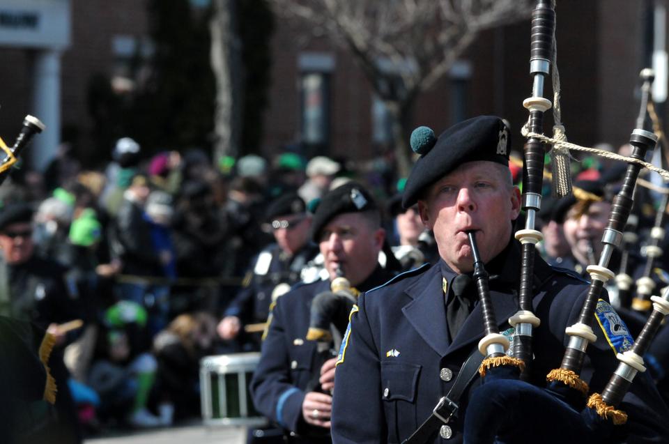 A musician playing the bagpipes proceeds down a South Boston street during the annual St. Patrick’s Day Parade on March 17. 