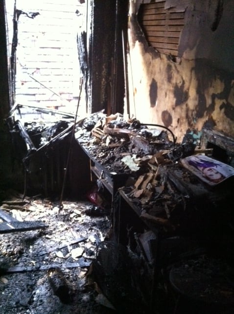 A desk in a Somerville apartment lays covered in rubble just hours after a fire broke out early in the morning of July 25. Carine Margez, a graduate student from France working at Harvard for the summer, was allowed to return to her apartment later that morning to take this photograph.