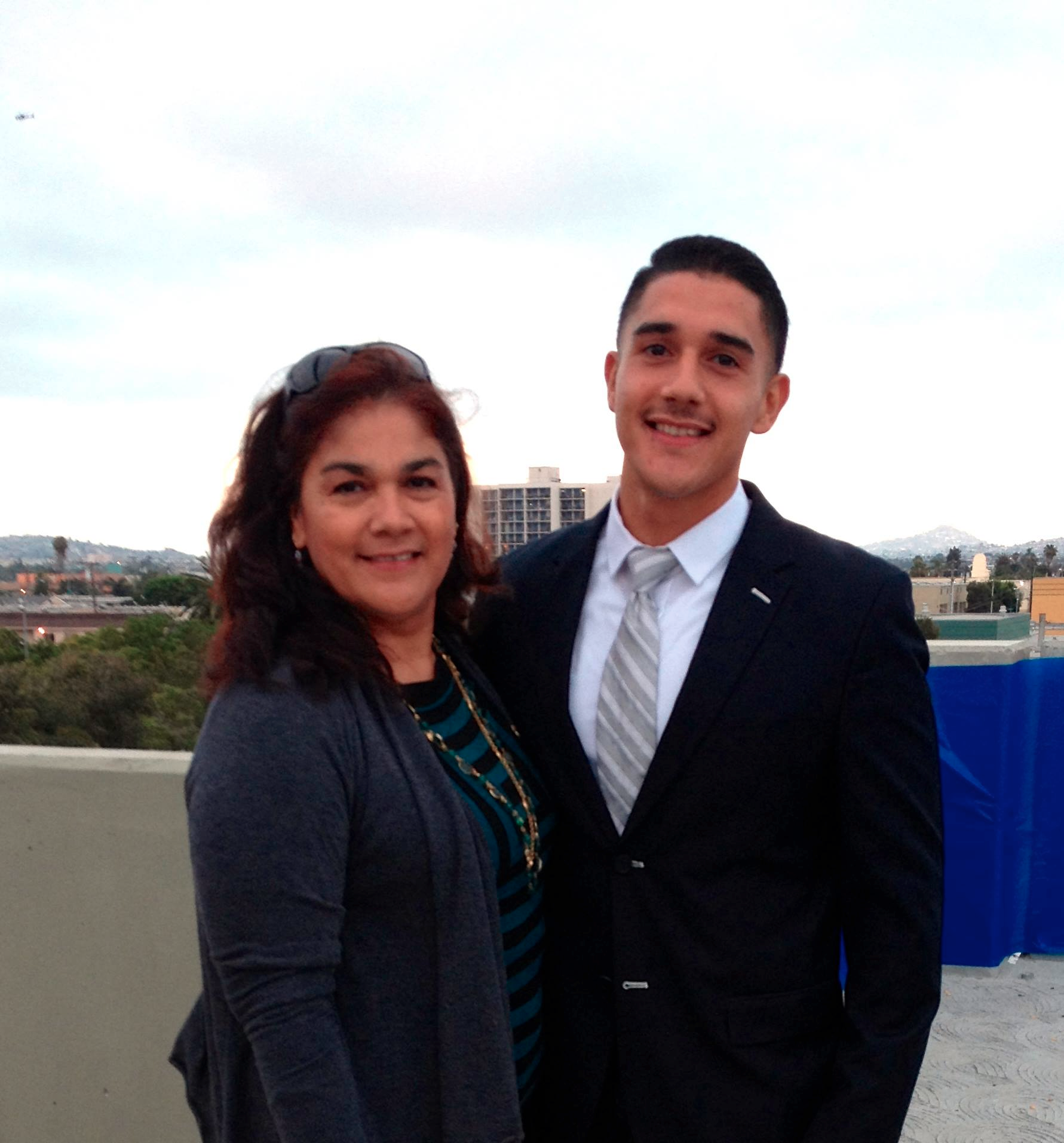 Jesse G. Sanchez standing next to his mother.