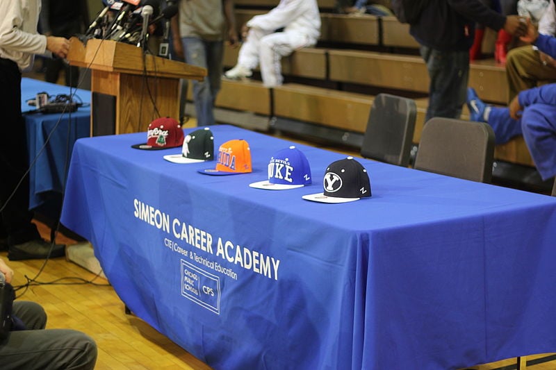 High-priority high school recruits sometimes take part in a hat selection ceremony, in which they verbally declare what college they decide to attend.