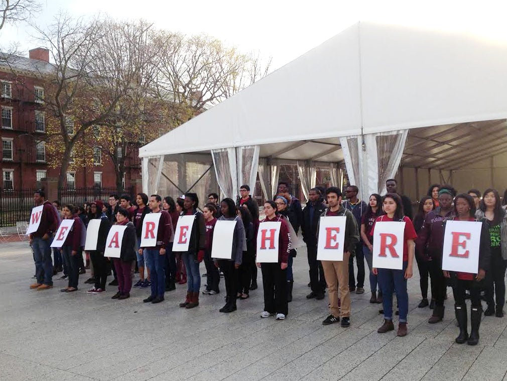 Members of the The Diversity Report stand in demonstration outside the Science Center to raise awareness about ways that Harvard can better support its diverse student population.