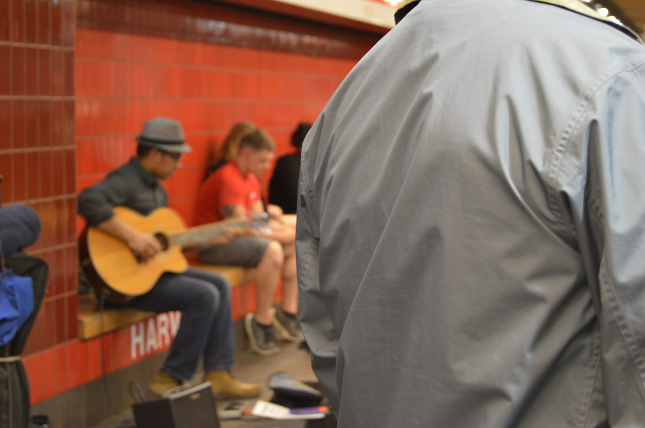 A musician plays for commuters in the Harvard Square subway station in May.