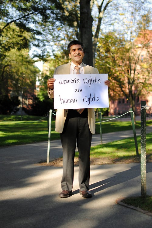 Dean Rakesh Khurana holds a sign that reads "women's rights are human rights" as part of the #emBODYindia campaign.