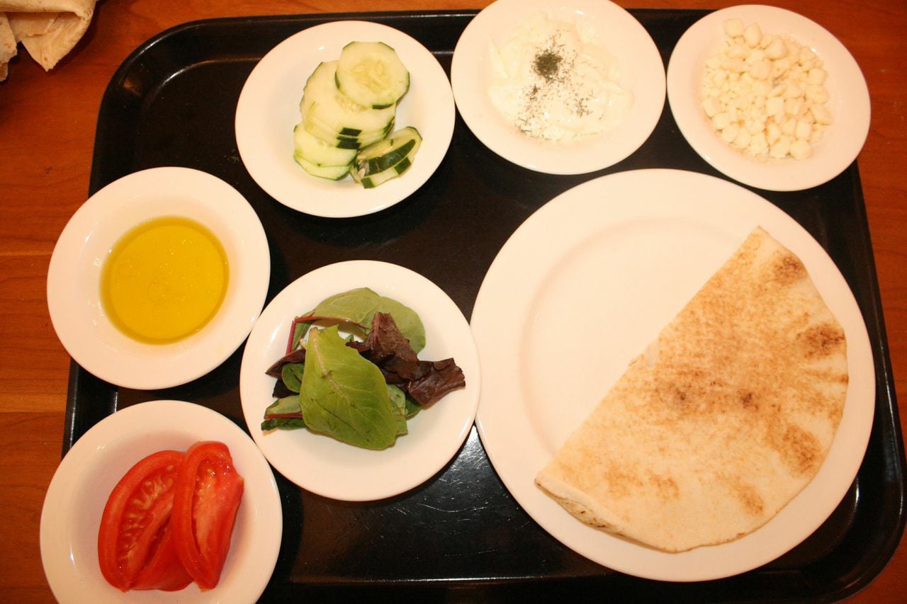 1 pita, whole wheat or white
1 small bowl Greek yogurt, sprinkled with dill
1 small bowl olive oil (2 parts) and lemon juice (1 part), mixed
Handful of cucumber slices, chopped into smaller pieces
Handful of tomato wedges
Handful of feta cheese