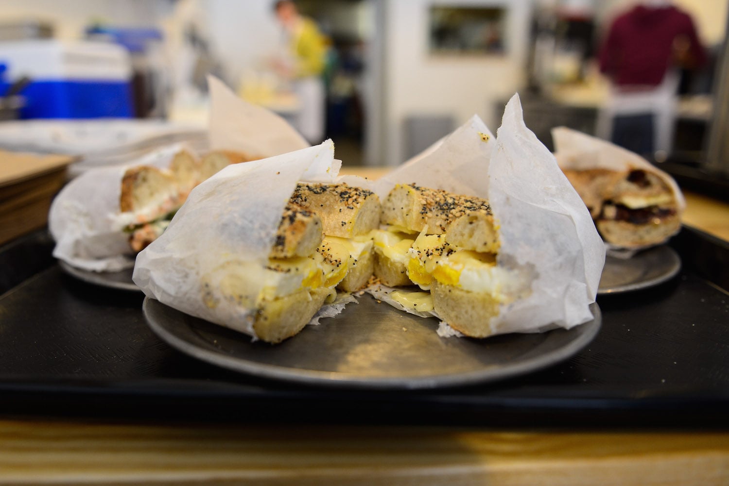 The Egg Sandwich at Bagelsaurus has a medium-fried egg, sharp cheddar, and mustard butter. FM recommends adding avocado and tomatoes (not pictured). 