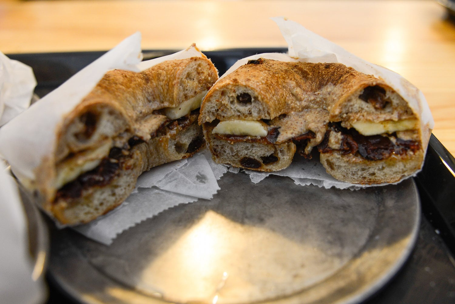 The T-Rex is a spin on Elvis' favorite sandwich, the peanut butter and banana. Bagelsaurus adds caramelized bacon, honey, and house-made almond butter to give the sandwich a unique twist.
