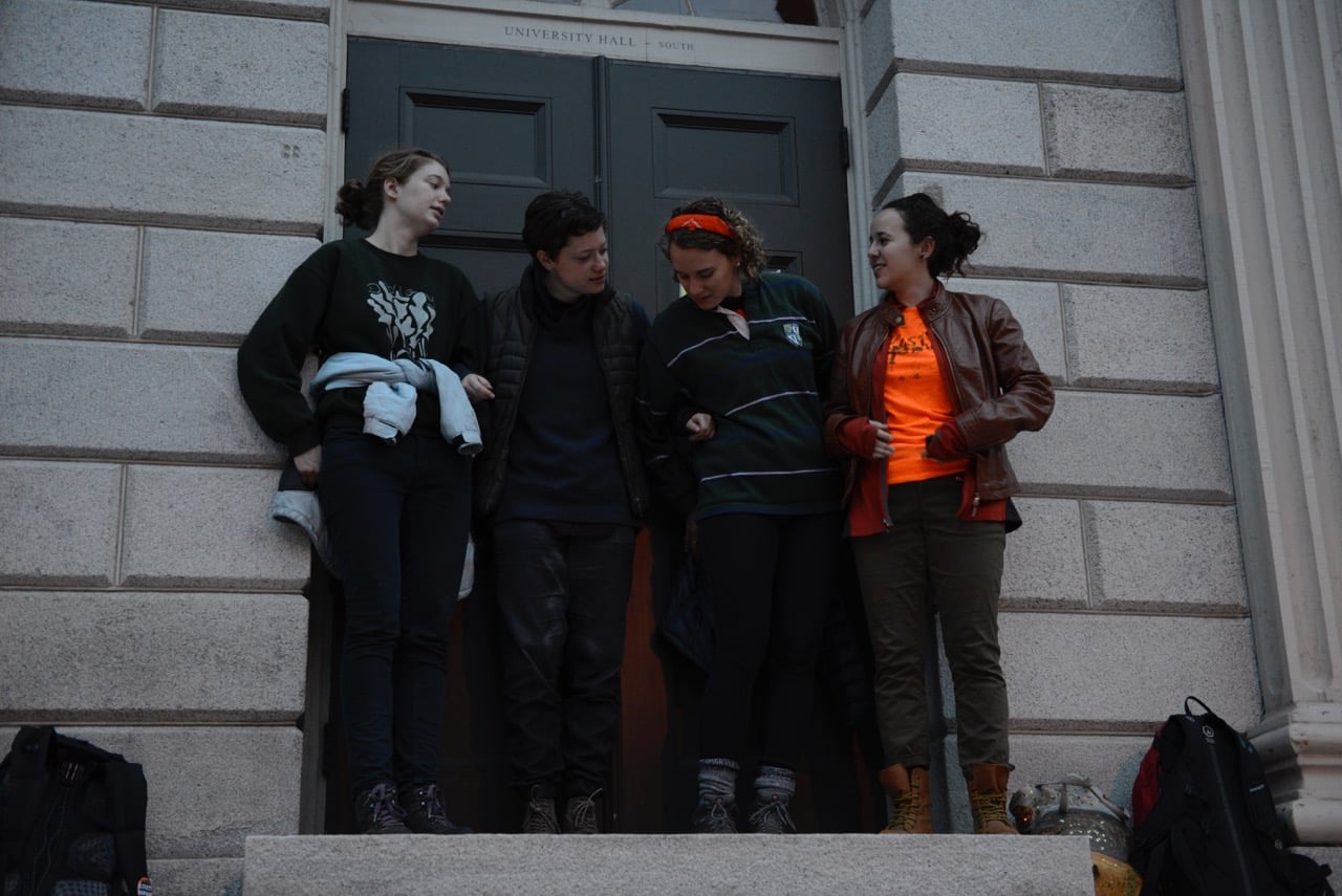 Protesters demanding that Harvard divest its endowment from fossil fuel companies began a blockade of University Hall early Tuesday morning.