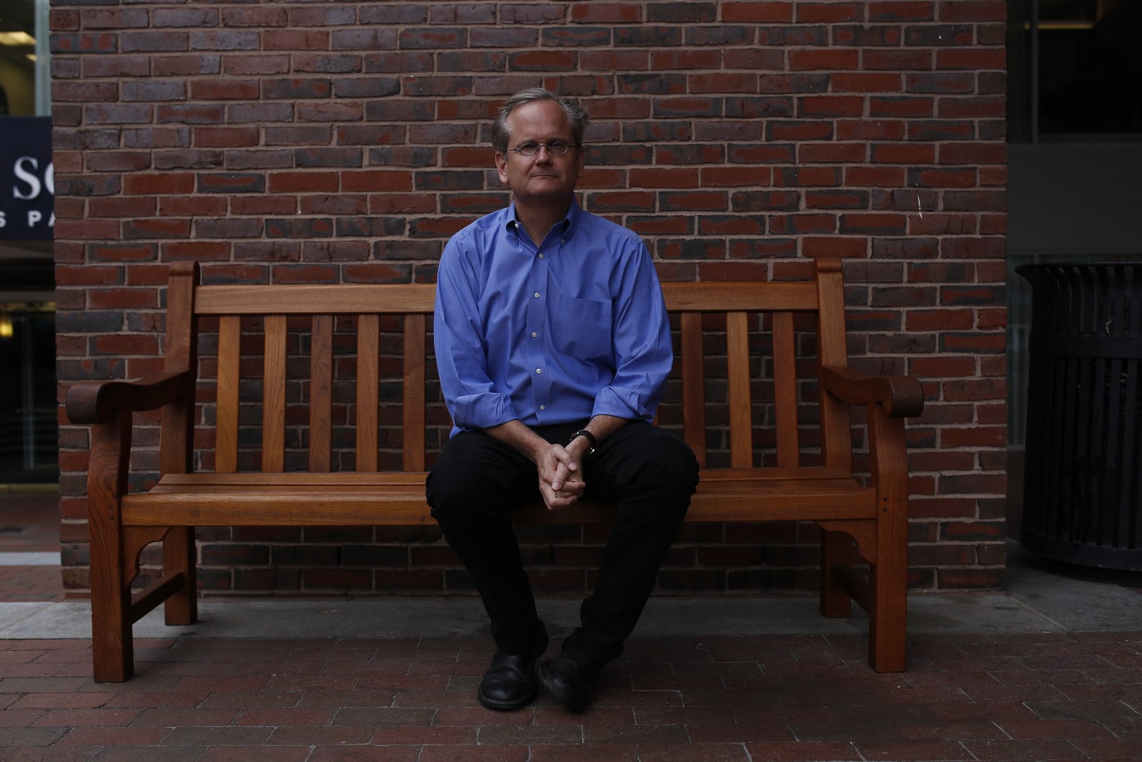 Larry Lessig poses for a photo on a bench outside the Charles Hotel on Sept. 10.
