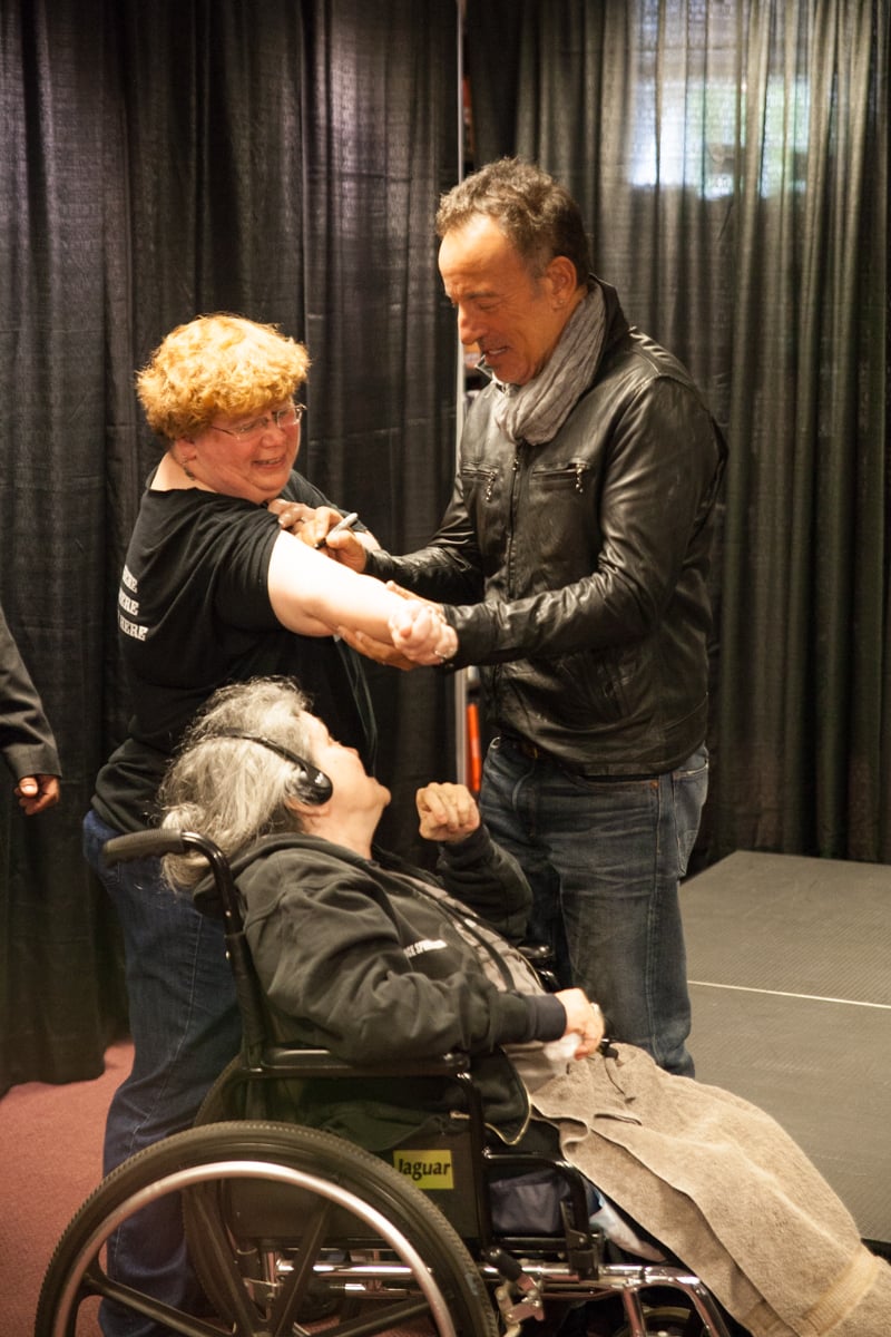 Bruce Springsteen signs a fan's arm during his special appearance at the Harvard Coop on October 10, celebrating the September 27 release of his autobiography, "Born to Run."