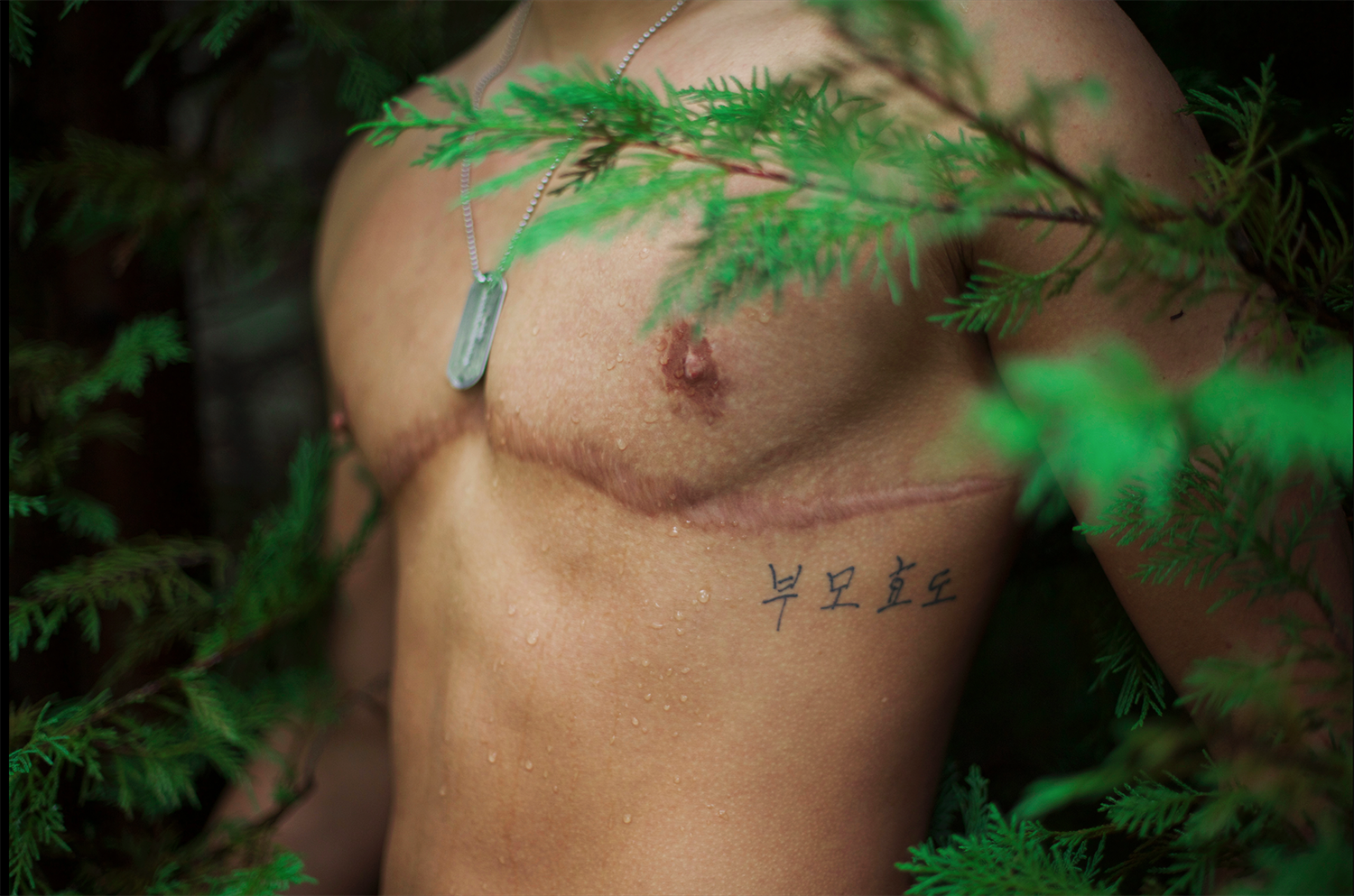 The tattoo on Bailar’s rib cage, which contains the Korean characters for “mother” “father” and “filial piety,” serves as a reminder of the strong bonds that exist in his family. It is his grandmother’s handwriting.