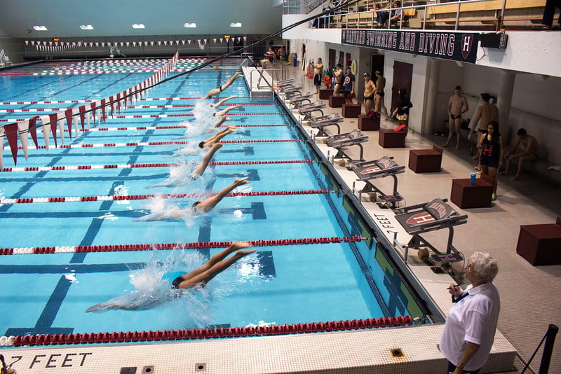 The Harvard men’s swimming and diving team competes in a 2017 meet.