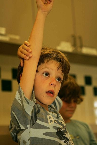 The overeager hand-raise is a dead giveaway.