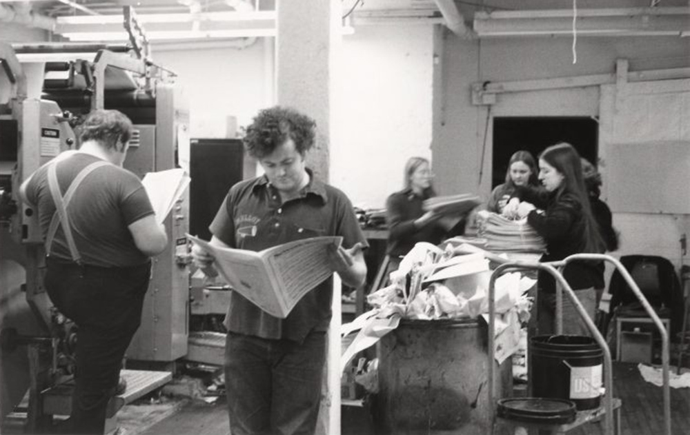 People read and work on printing the Seventh Sister, a student-produced feminist magazine, in the basement of The Crimson. 