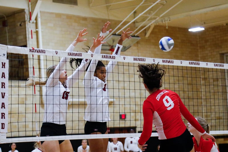 Middle blockers Jocelyn Meyer and Maclaine Fields rise up to meet the ball at the net in the Crimson's win over Cornell.