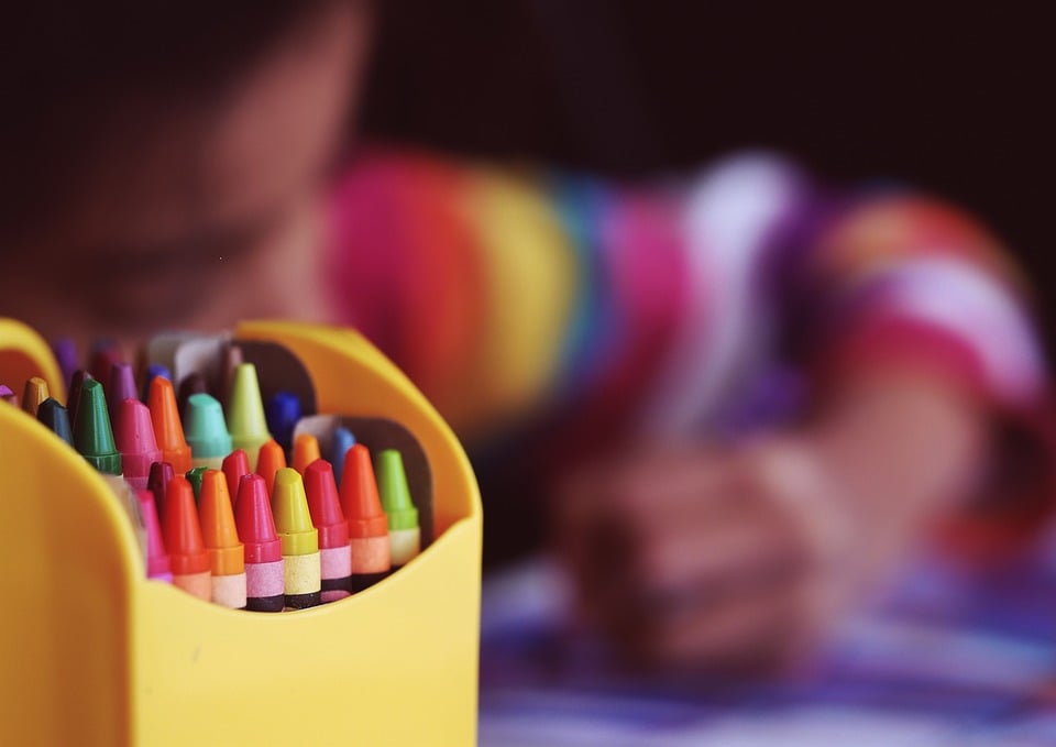 This child could be drawing a Mother's Day card. Who knows?
