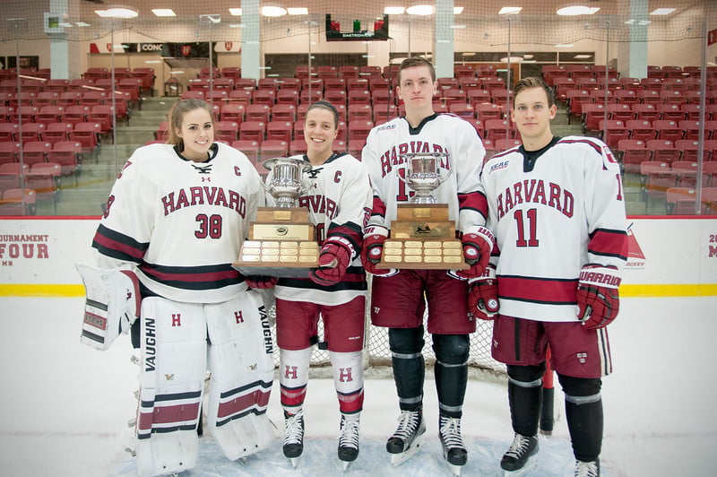 The 2015 Harvard hockey seniors show off the prizes of their respective conference championships.